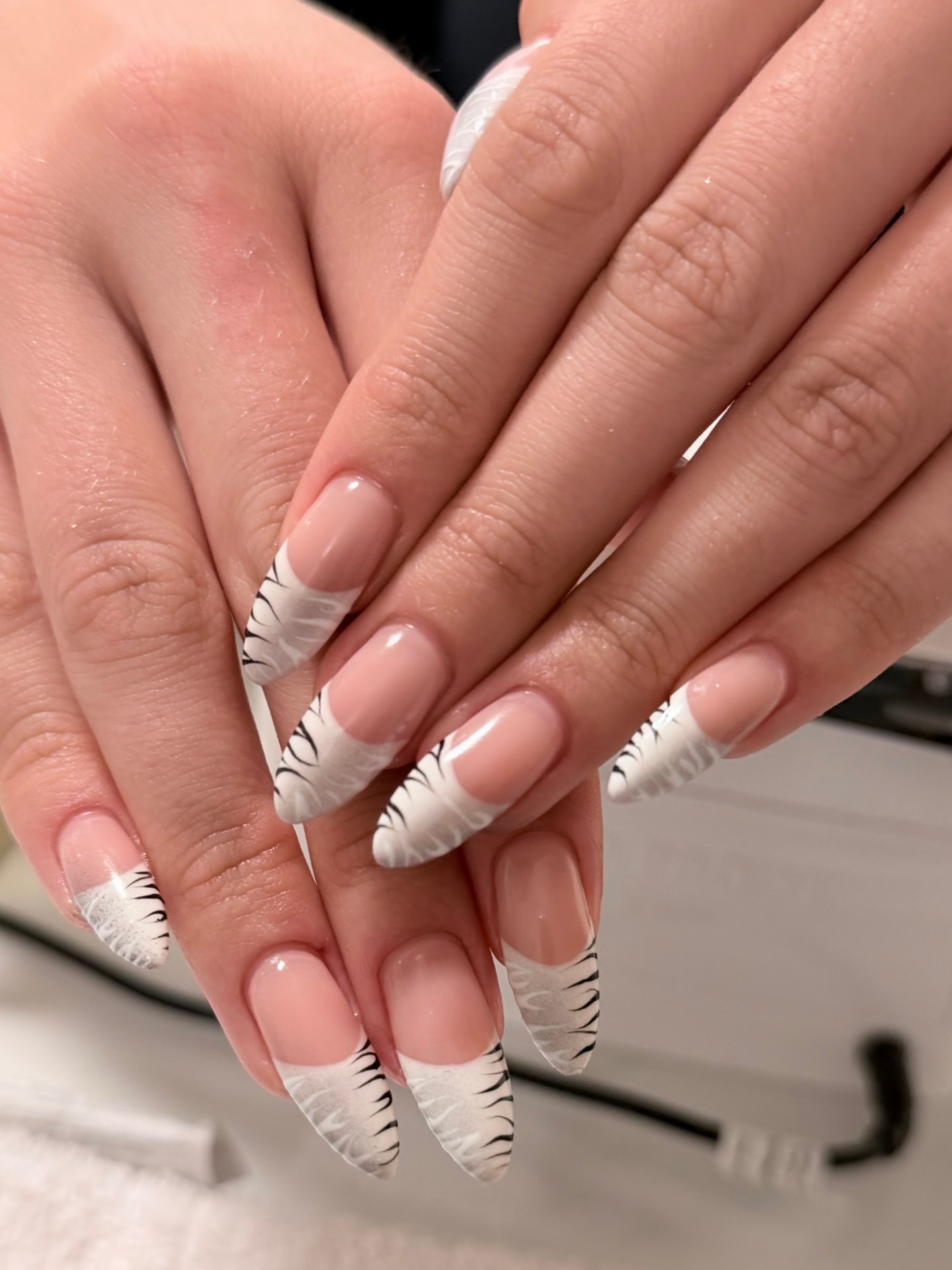 Long nude nails with white smoke French tips and fine black line detailing